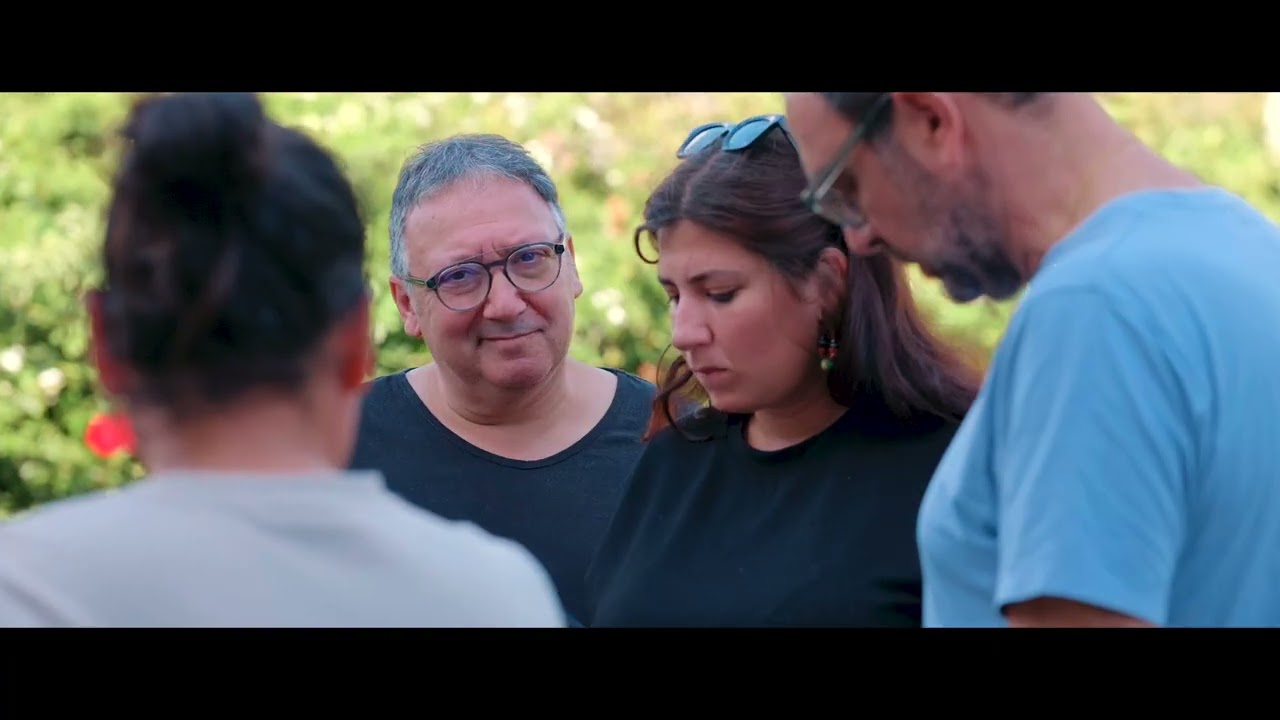 The production team reviewing footage outdoors during the Sensei Maison film shoot